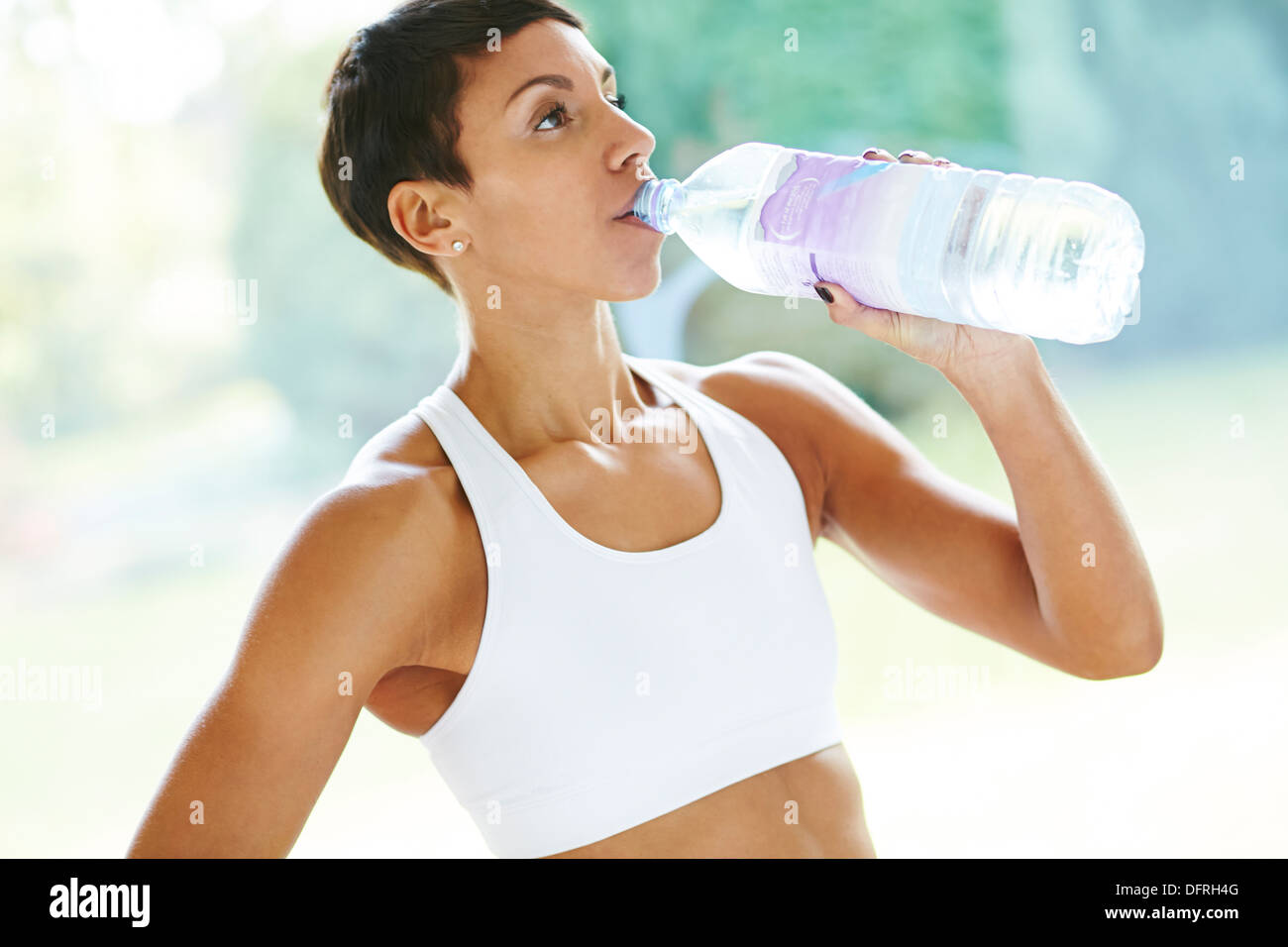 Girl drinking water after exercise Stock Photo Alamy