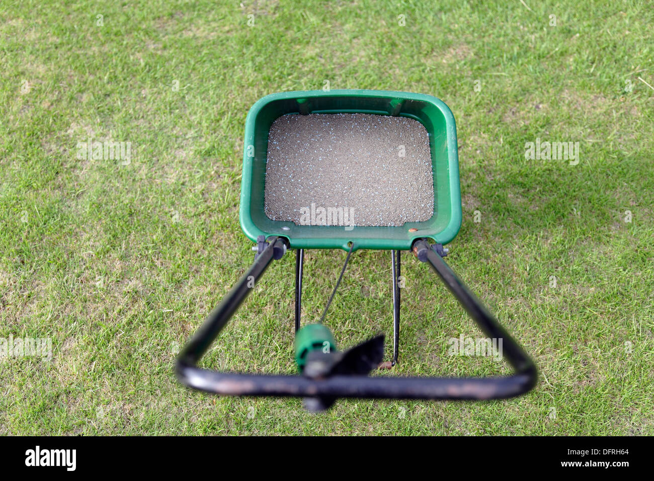 Grass food in a wheeled spreader, UK Stock Photo