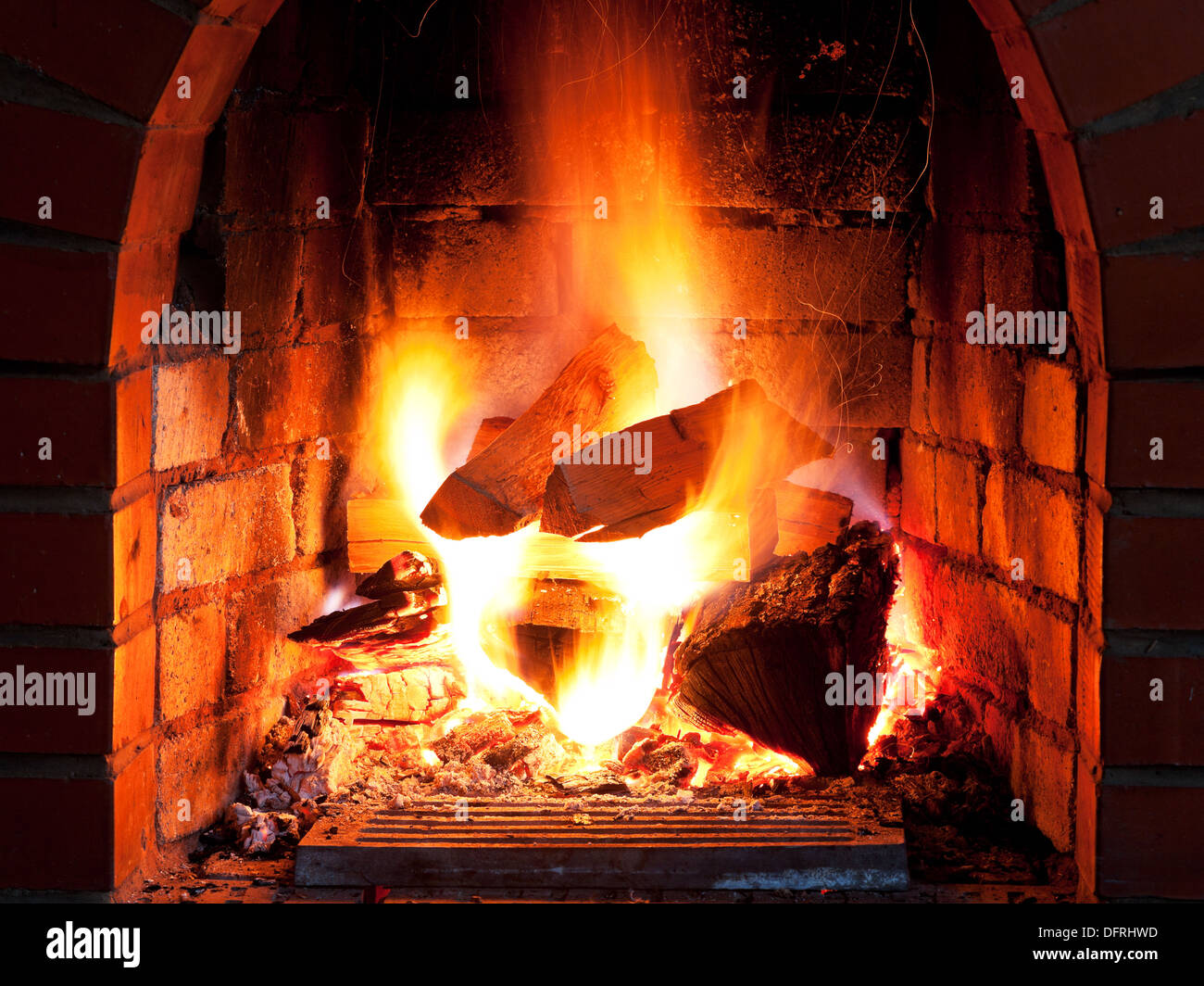 flames of fire in fireplace in evening time Stock Photo