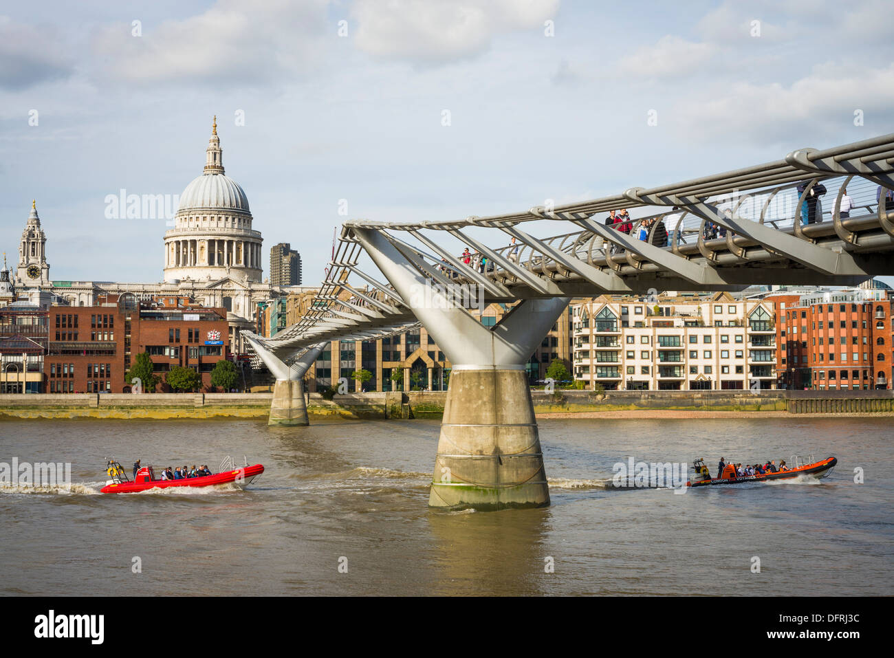 Two rib boats pass under the Millennium Bridge and St. Paul's Cathedral, River Thames, City of London, UK Stock Photo