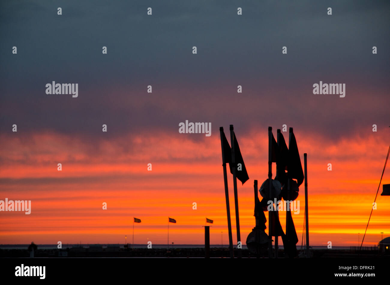 Silhouette of fishermans flags in sunset Stock Photo
