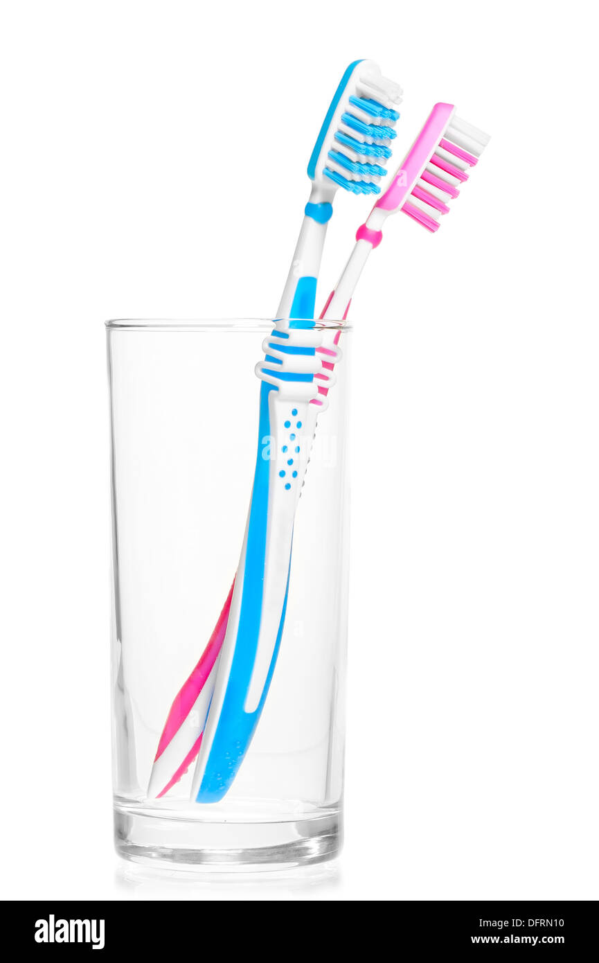 pair of new toothbrushes in a glass on a white background Stock Photo ...