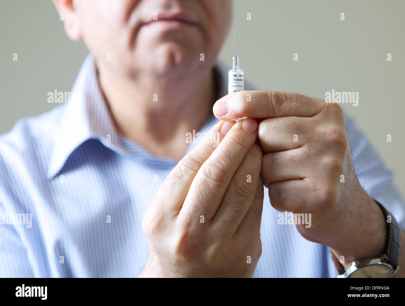 Doctor GP prepares to give the flu jab injection to a patient Stock Photo