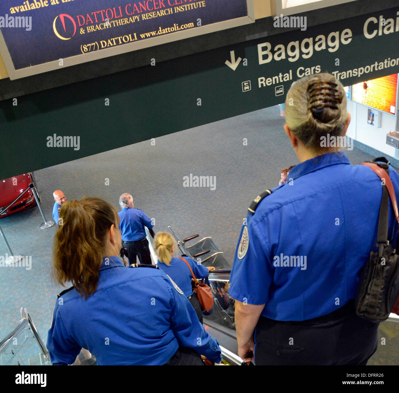 TSA agents desending escalator for shift change at Sarasota Bradenton