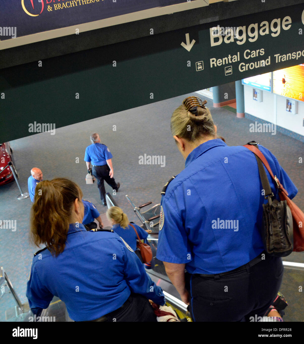 TSA agents desending escalator for shift change at Sarasota Bradenton