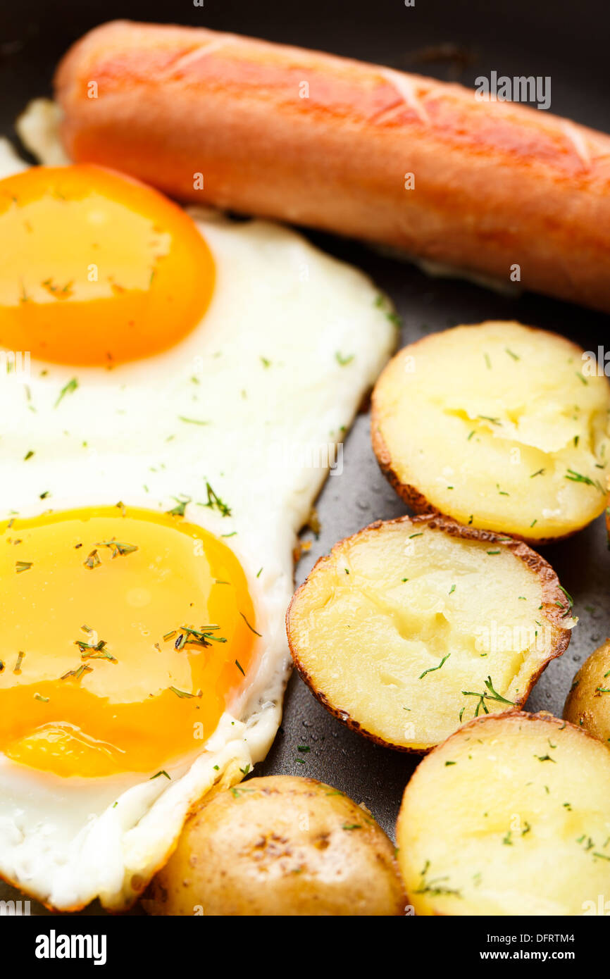 Breakfast with eggs, sausage and potato Stock Photo