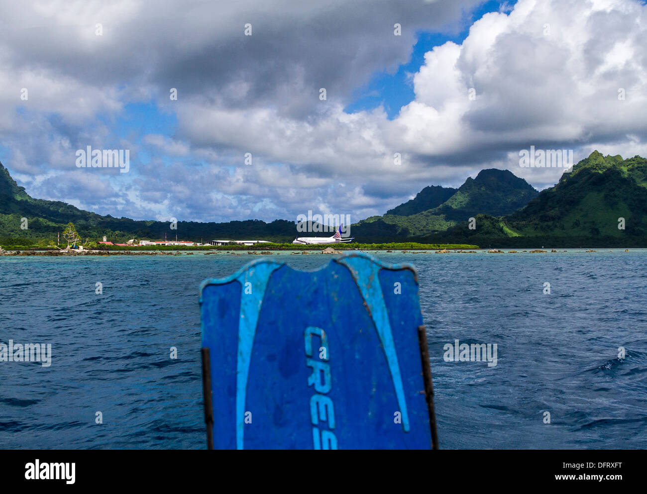 View from dive boat with diver who just arrived on that jet, getting ready for first dive on Kosrae Stock Photo
