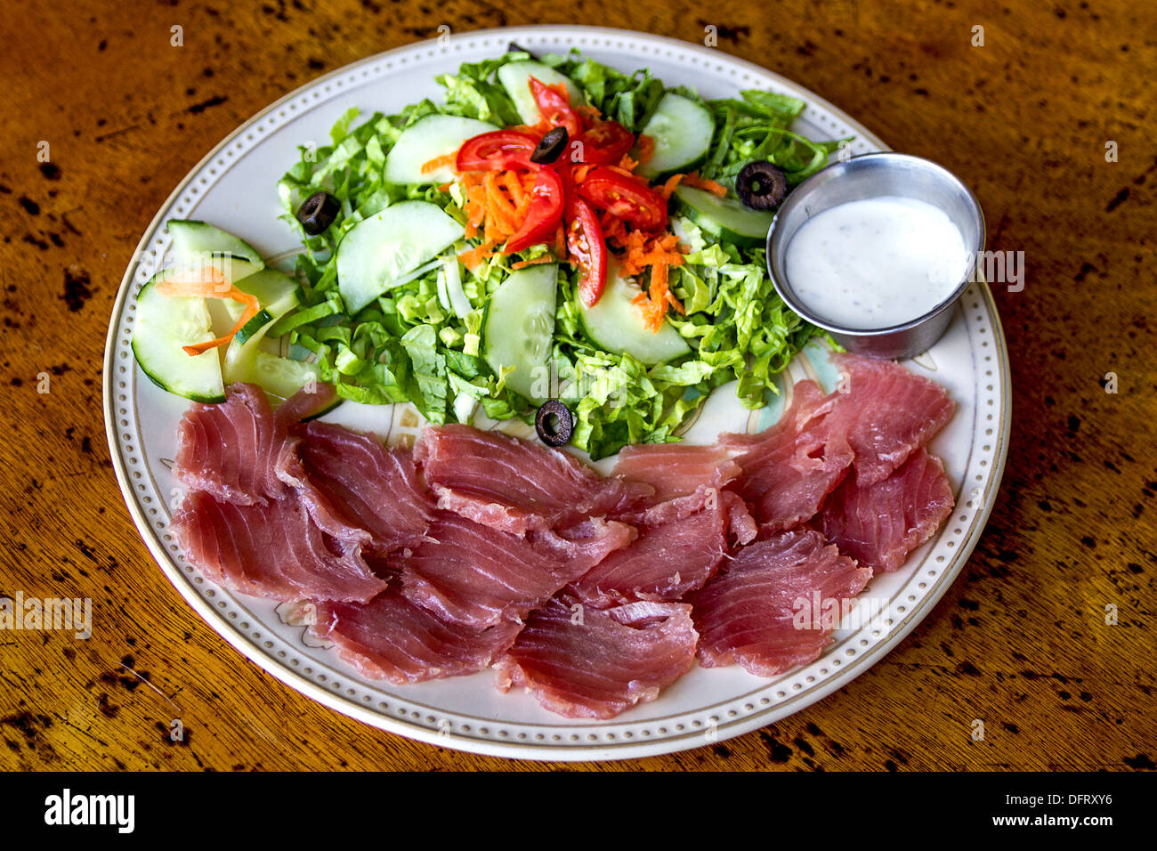 Yellowfin tuna sashimi, fresh raw fish served with a green salad. Stock Photo