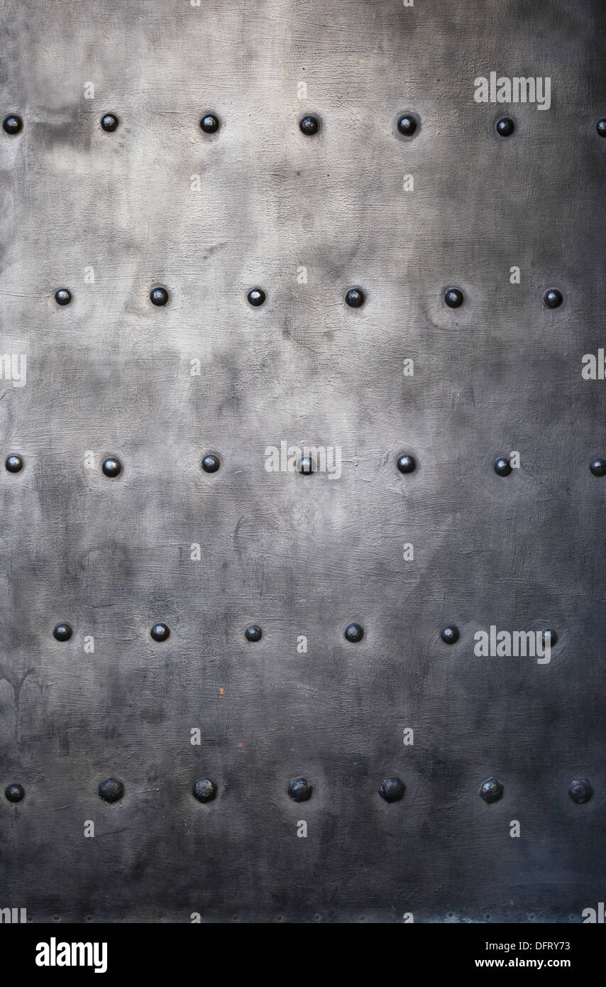Black grunge metal plate or armour texture with rivets as background ...