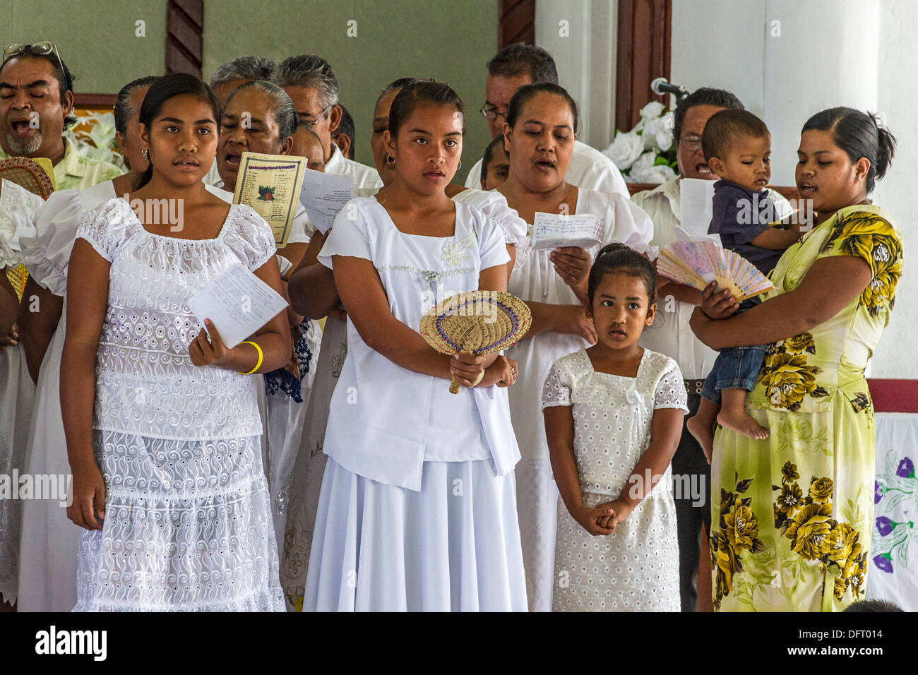 Micronesian women dressed in white lace sing four part choral harmony during church service in Tafunsak, Kosrae, Micronesia Stock Photo