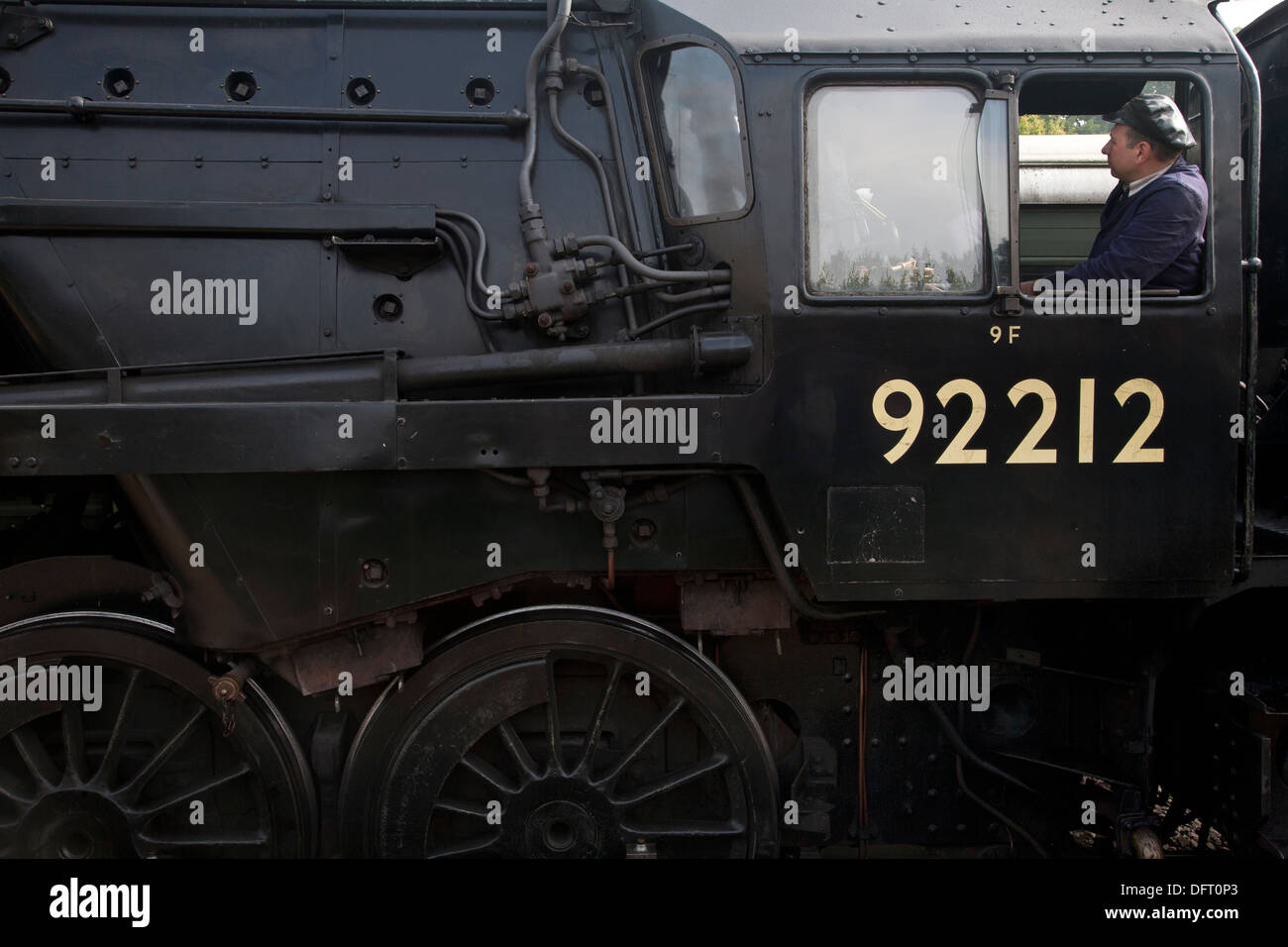 Steam locomotive 92212 with train driver in window on the Bluebell Railway Stock Photo