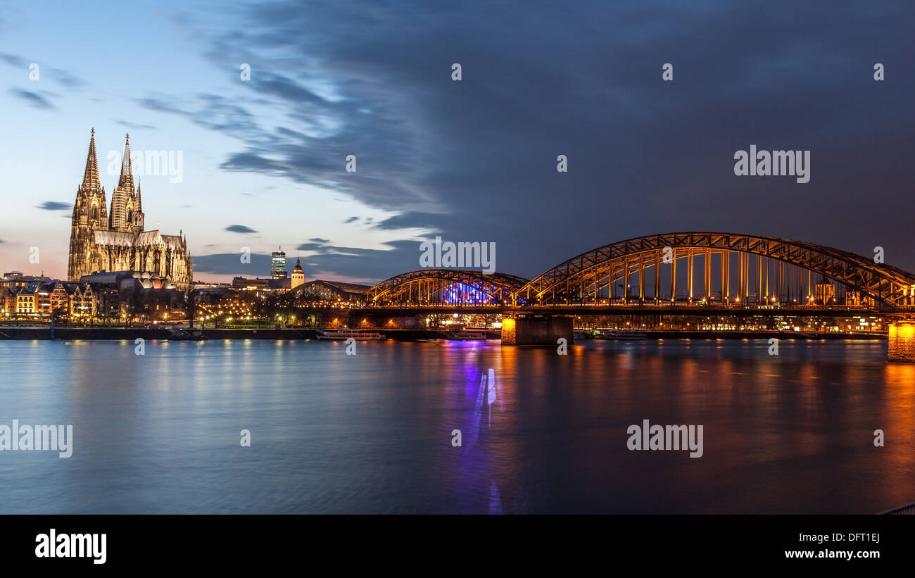 Cologne Cathedral and Hohenzollern bridge at dusk Stock Photo