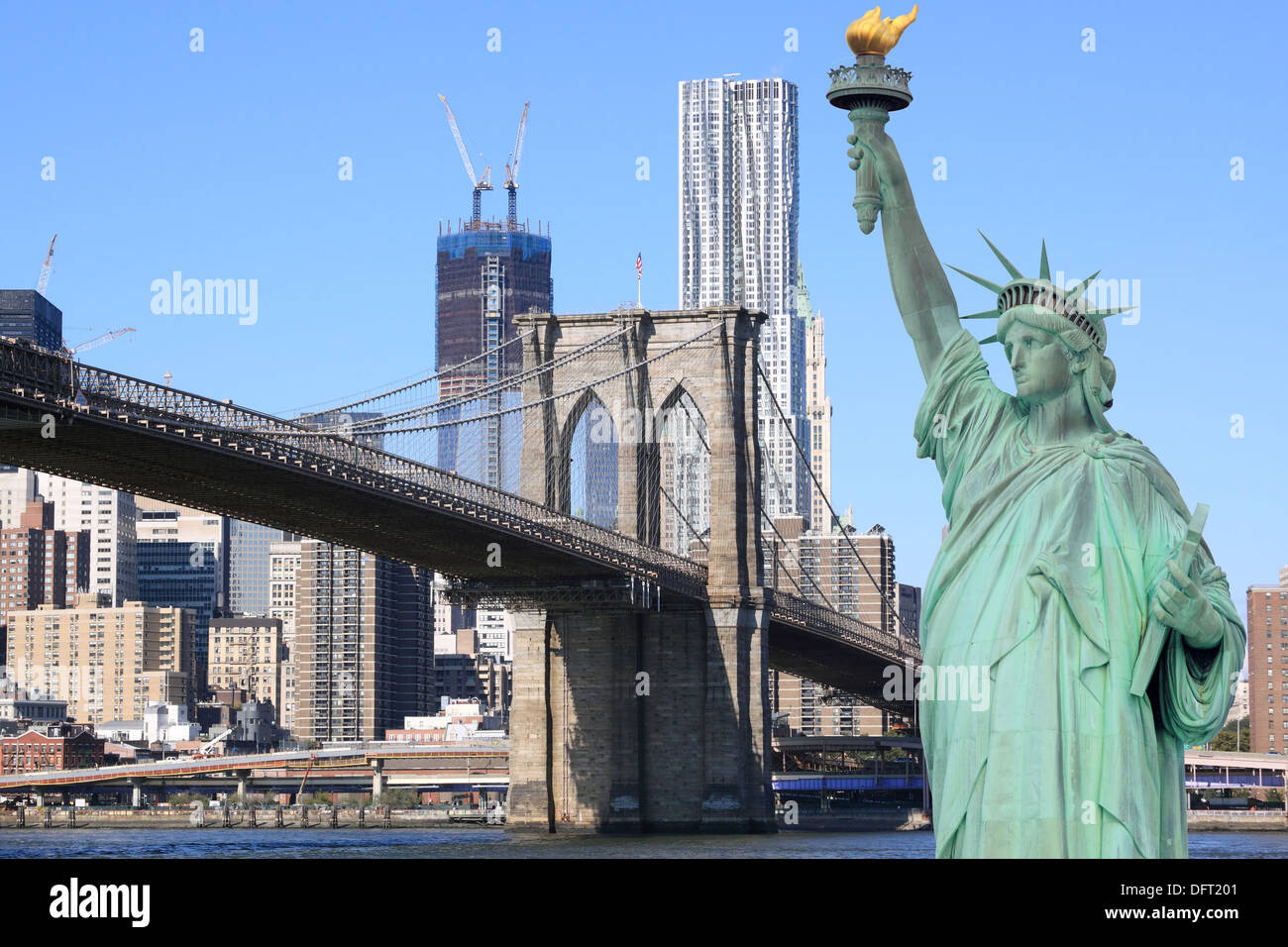 Brooklyn Bridge and The Statue of Liberty at Night, New York City Stock