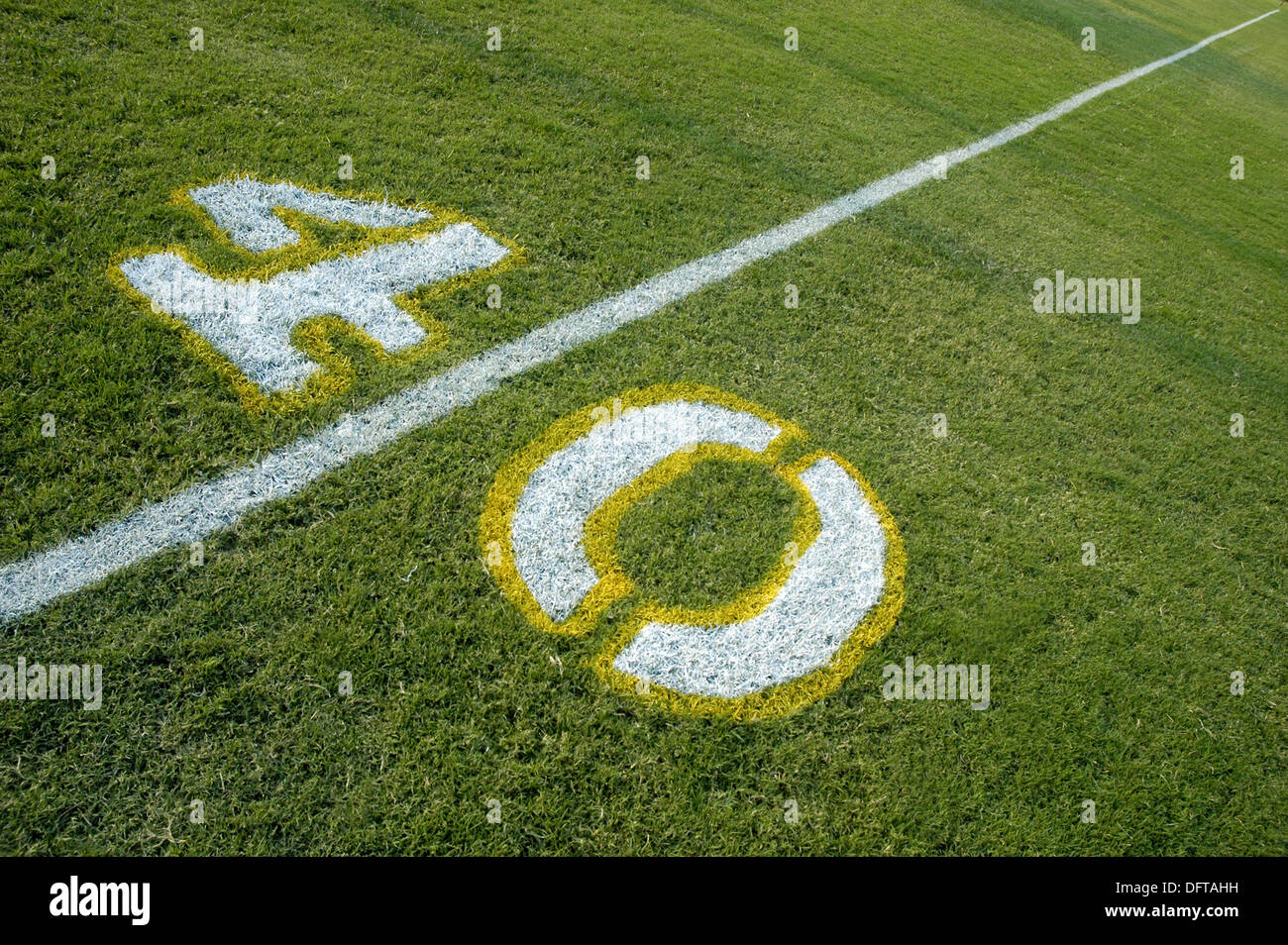 Painted yardage lines of football field, some being painted Stock Photo