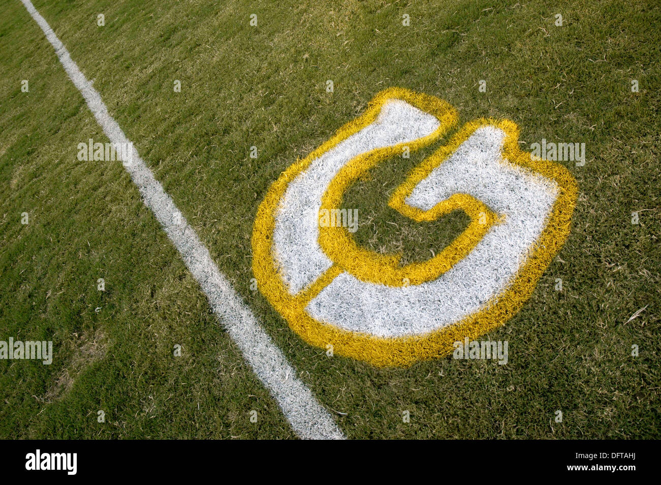 Painted yardage lines of football field, some being painted Stock Photo