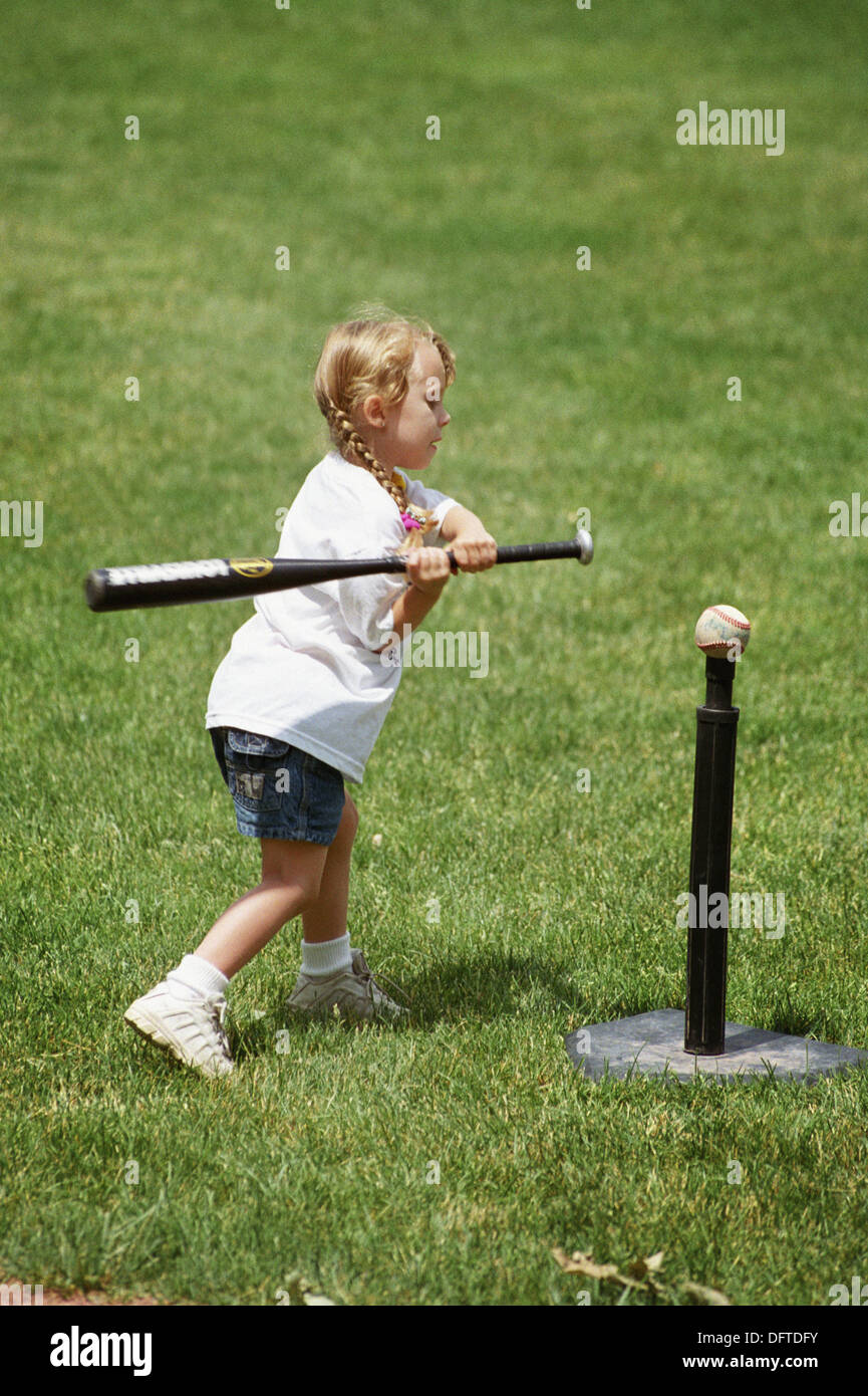 Learning how to hit a ball off of a tee Stock Photo Alamy