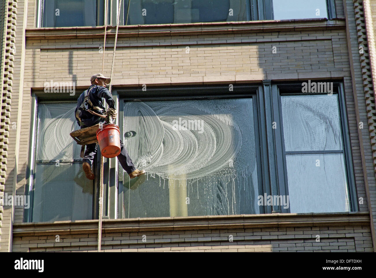 Window washers work at extreme heights to clean windows on tall