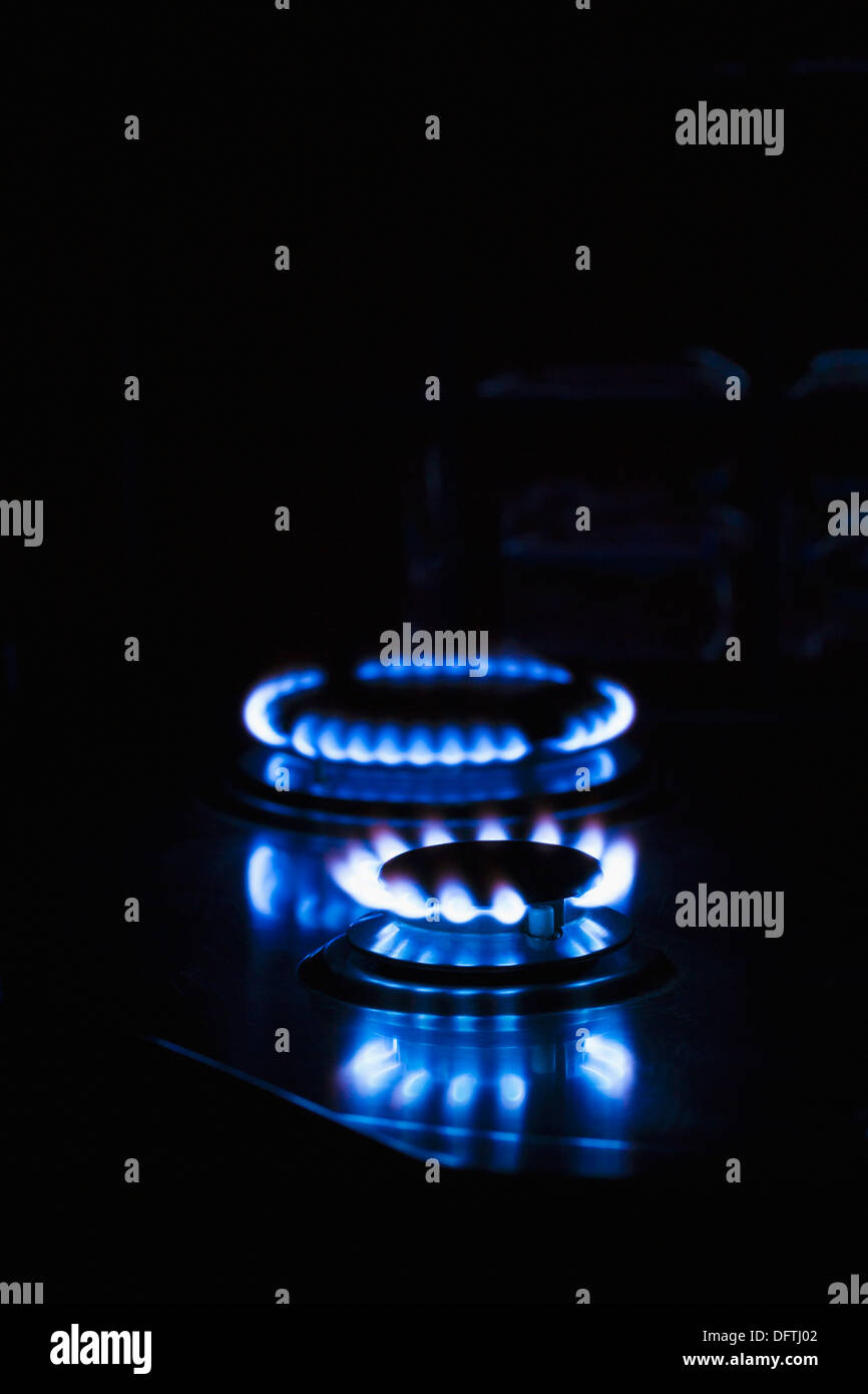 Gas hob cooker flames glowing ablaze in the dark Stock Photo Alamy