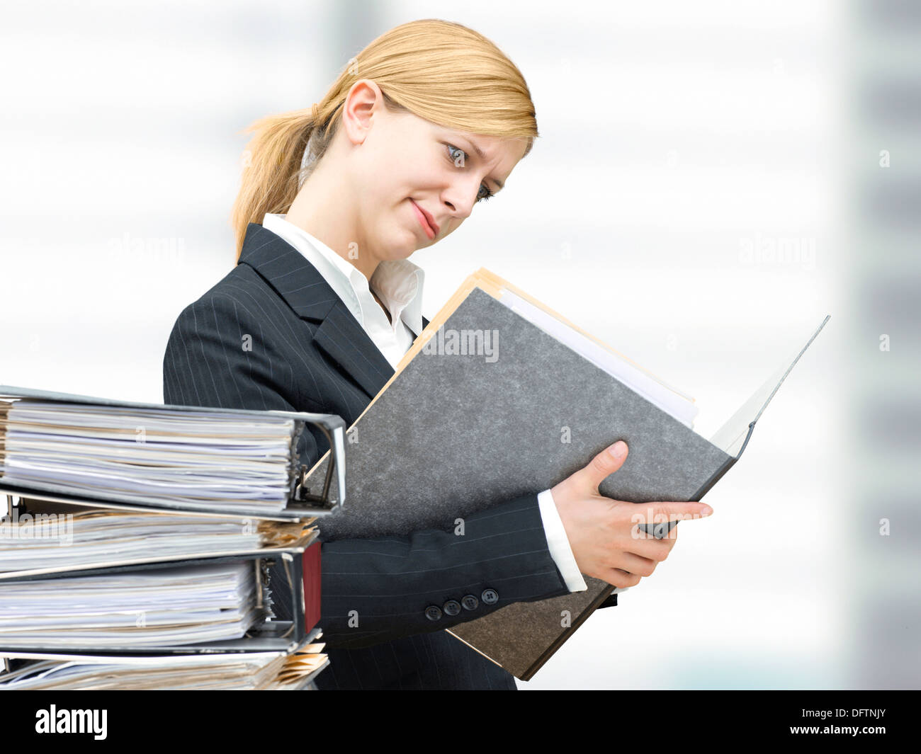 Young business woman reading in a folder Stock Photo