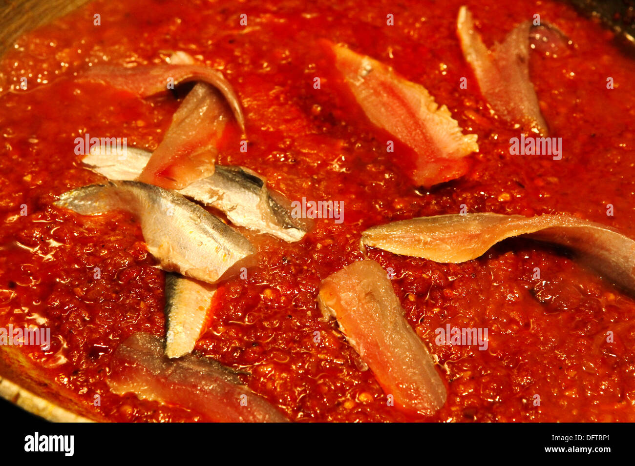 sardines cooking in tomato sauce Stock Photo Alamy