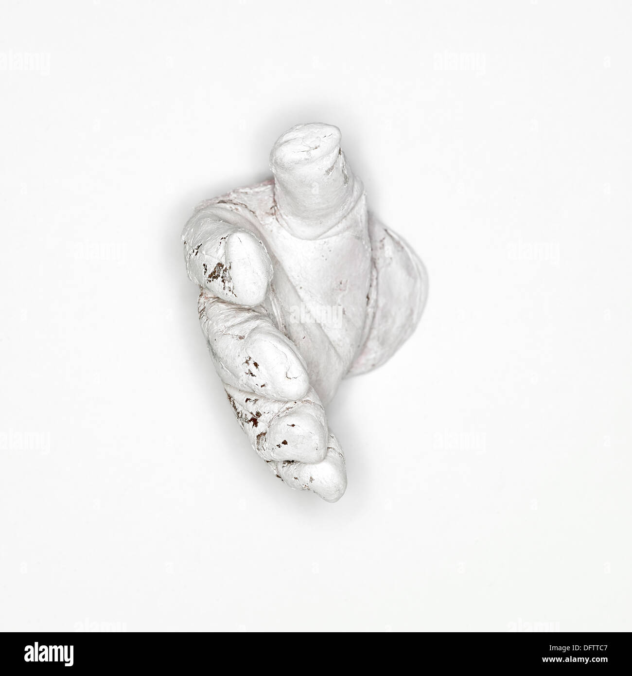 white paint covered glove on a white background reaching out Stock Photo