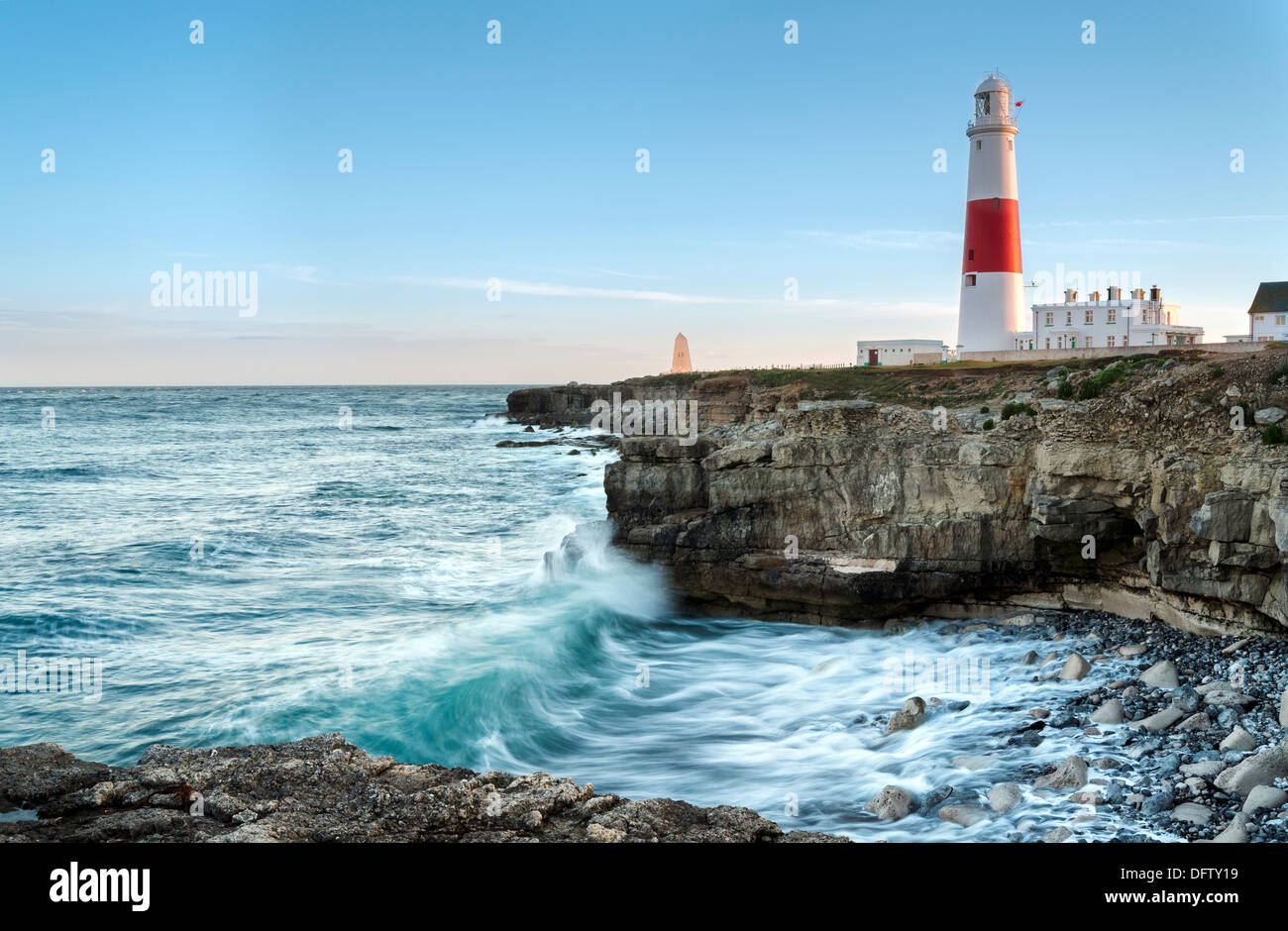 Waves crashing over rocks at Portland Bill lighthouse on the Jurassic Coast in Dorset Stock Photo