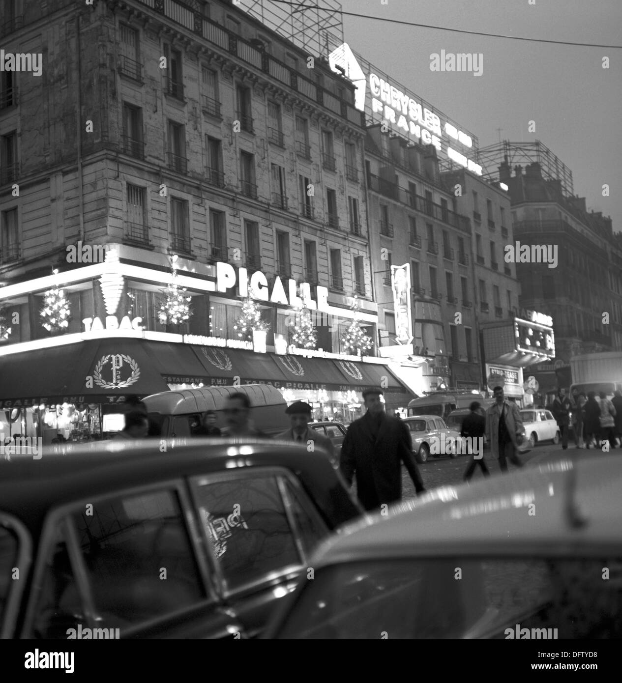 View fo the restaurant Pigalle at the square with the same name in the quarter Montmartre in Paris, France, In November 1970. To the right, an advertisement for Chrysler cars. The quarter is famous for, among other things, the Moulin Rough and the artists that used to live here. Photo: Wilfried Glienke Stock Photo