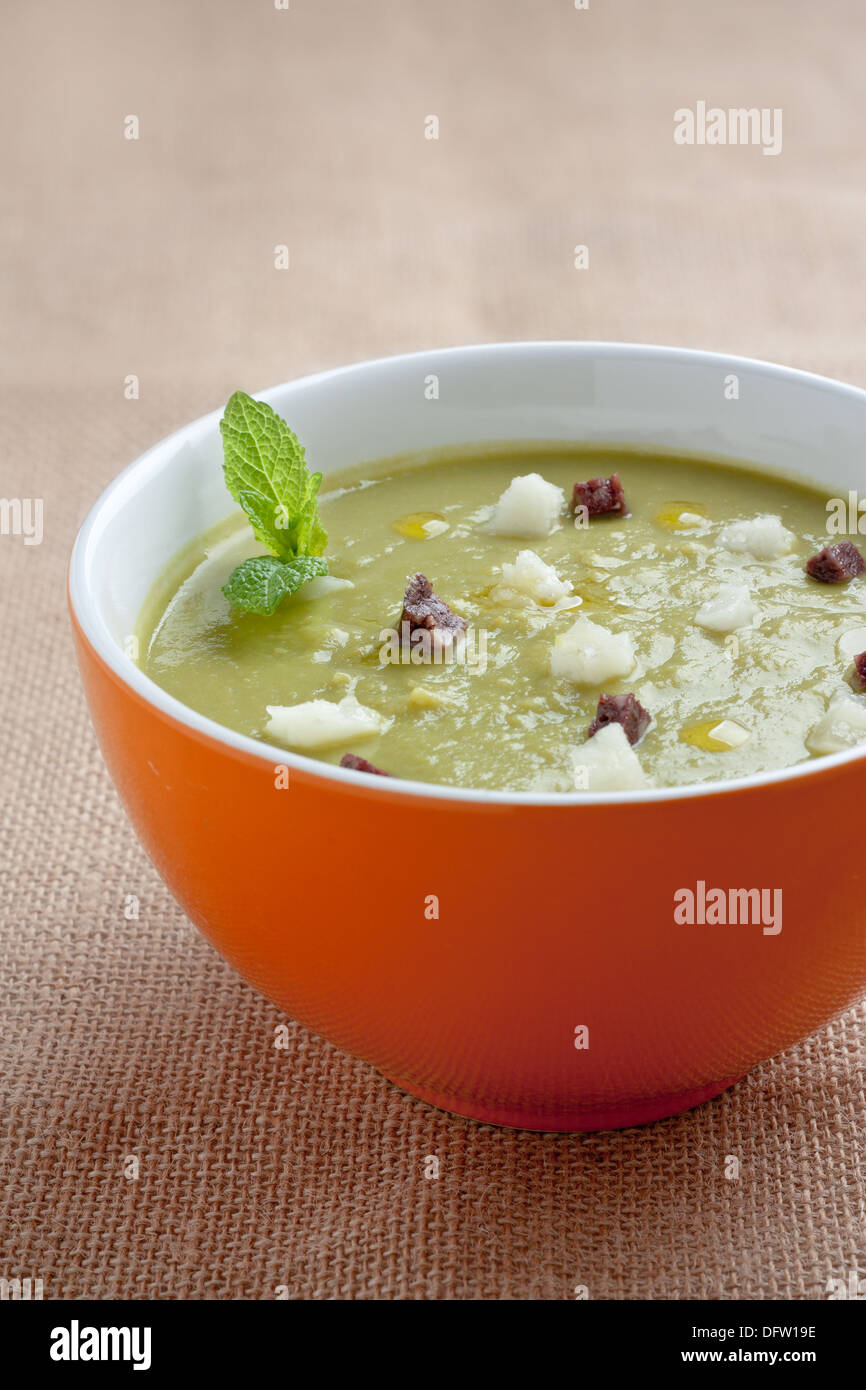Vegetal cream on a bowl with sausage and cheese Stock Photo