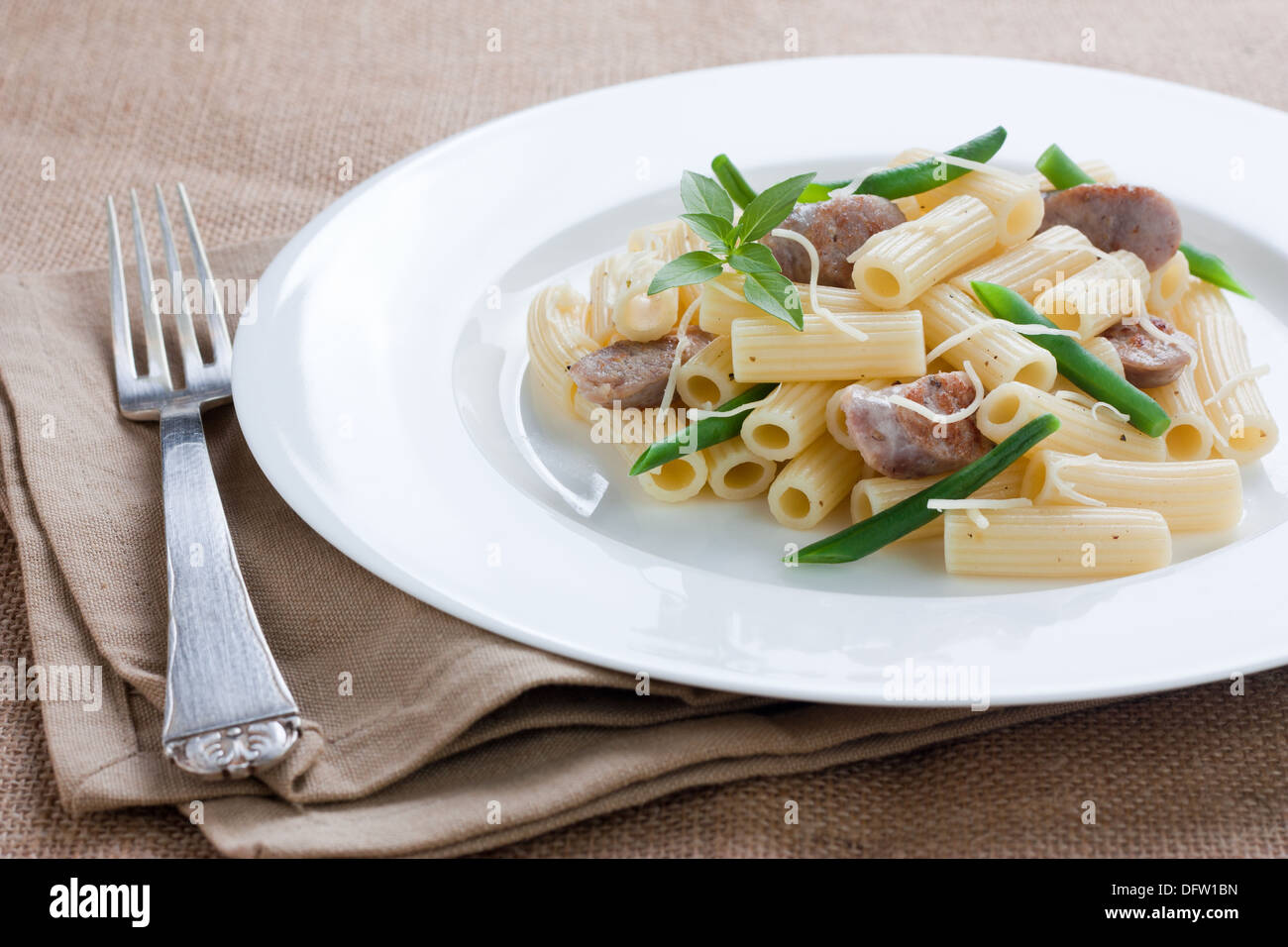 Rigatoni with sausage, green beans and grated cheese Stock Photo