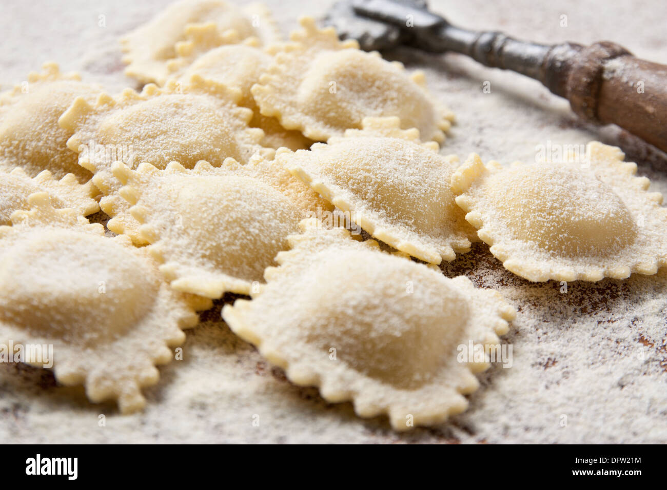 Making homemade ravioli with a wooden roller Stock Photo
