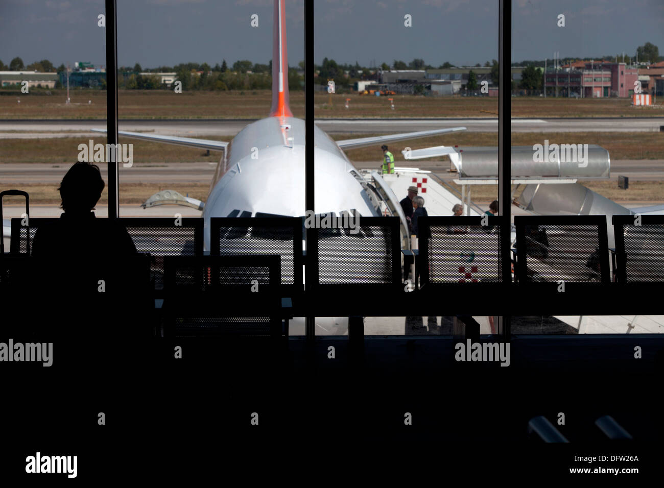 Passengers waiting to board an aircraft in an airport terminal Stock Photo