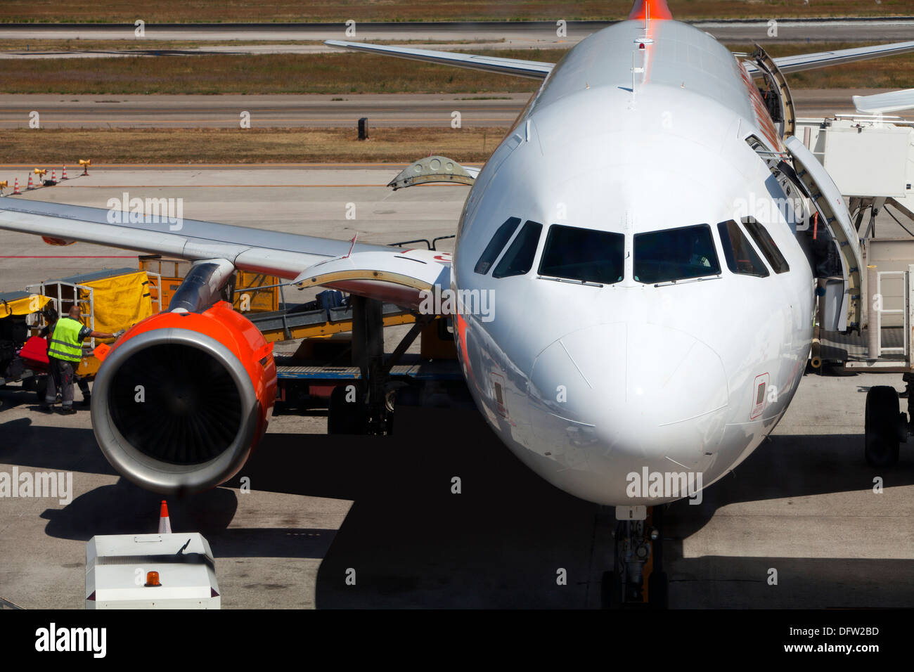 Baggage handlers loading an aircraft prior to take off Stock Photo
