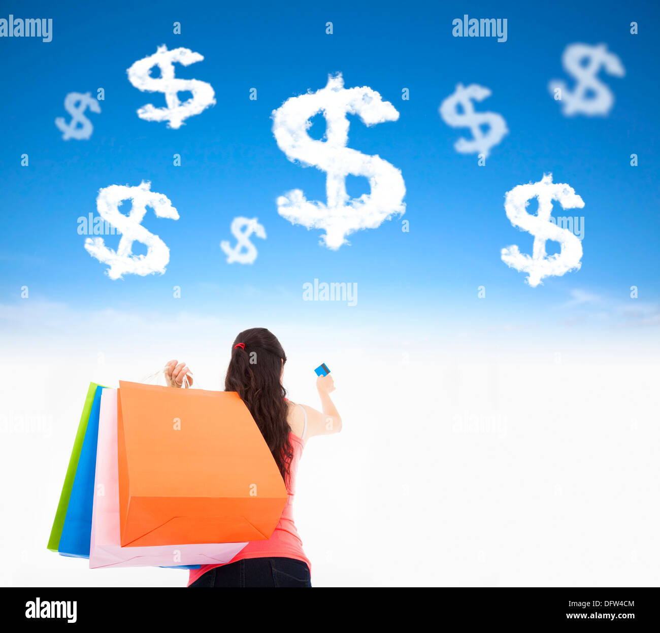 young woman holding shopping bags and credit card with money cloud Stock Photo