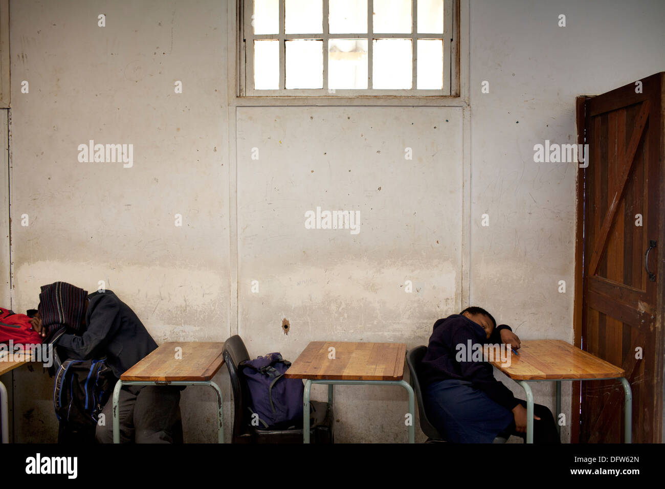 African schoolchildren sleep during their lunch break at Thandokhulli school, Mowbray, Cape Town. Stock Photo