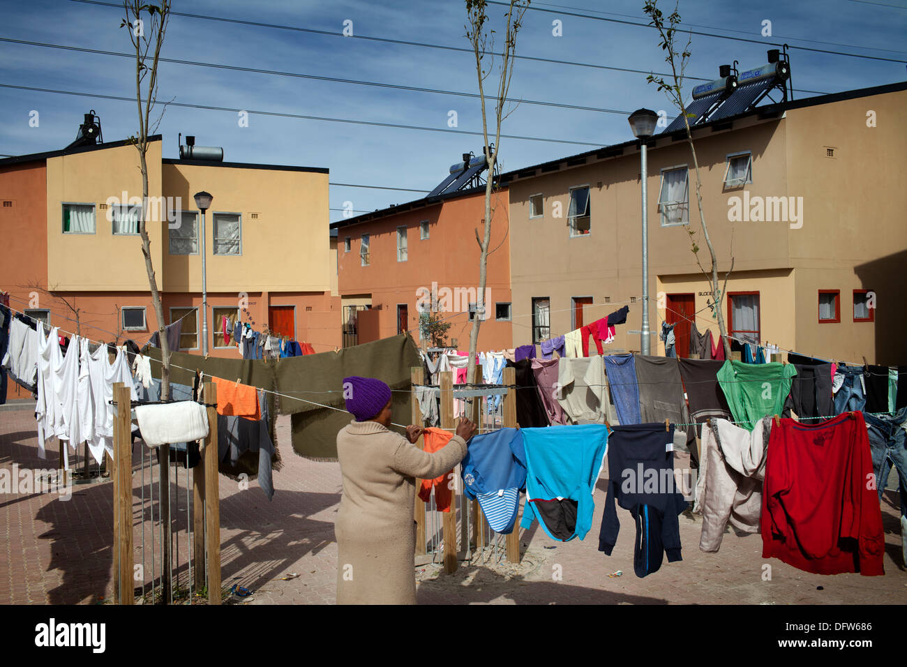 Cape Town South Africa - A woman hangs up her washing in a newly developed RDP housing project in langa where all houses are Stock Photo