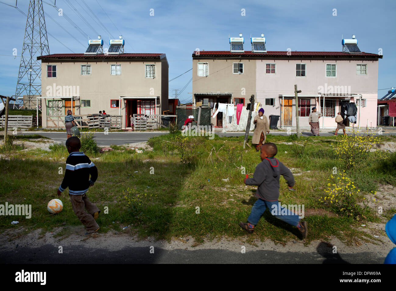 Cape Town South Africa - Children play football in a newly developed RDP housing project in Langa where all houses are equipped Stock Photo