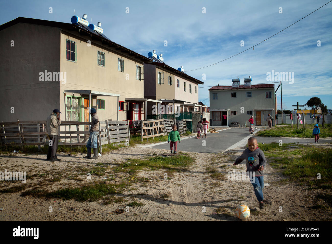 Cape Town South Africa - Children play football in a newly developed RDP housing project in Langa where all houses are equipped Stock Photo