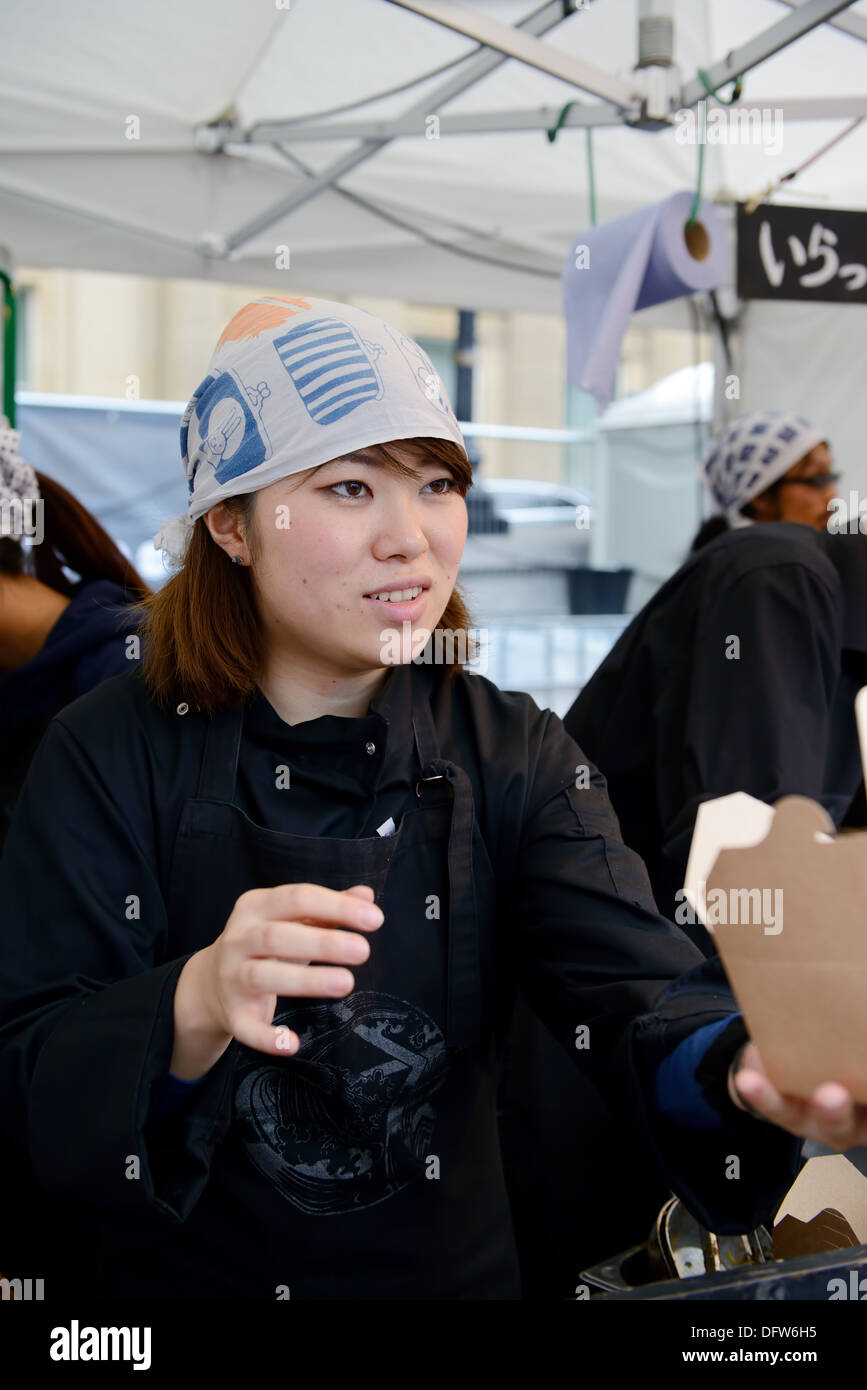 Japanese girl serving food at matsuri festival in London England. Saturday 5th October 2013 Stock Photo