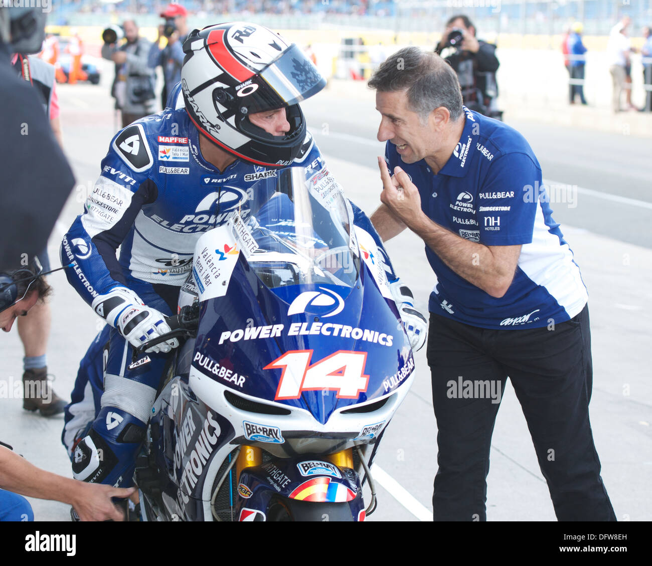 Randy De Puniet the Power Electronics Aspar Team rider speaks to his team in the Pit Lane during
