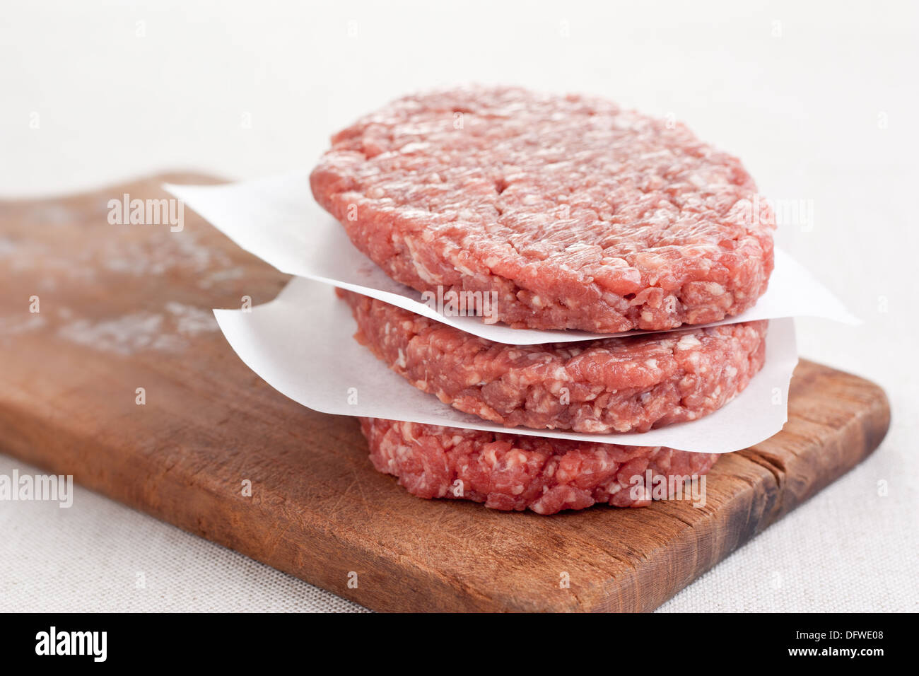 Pile of three raw hamburgers Stock Photo