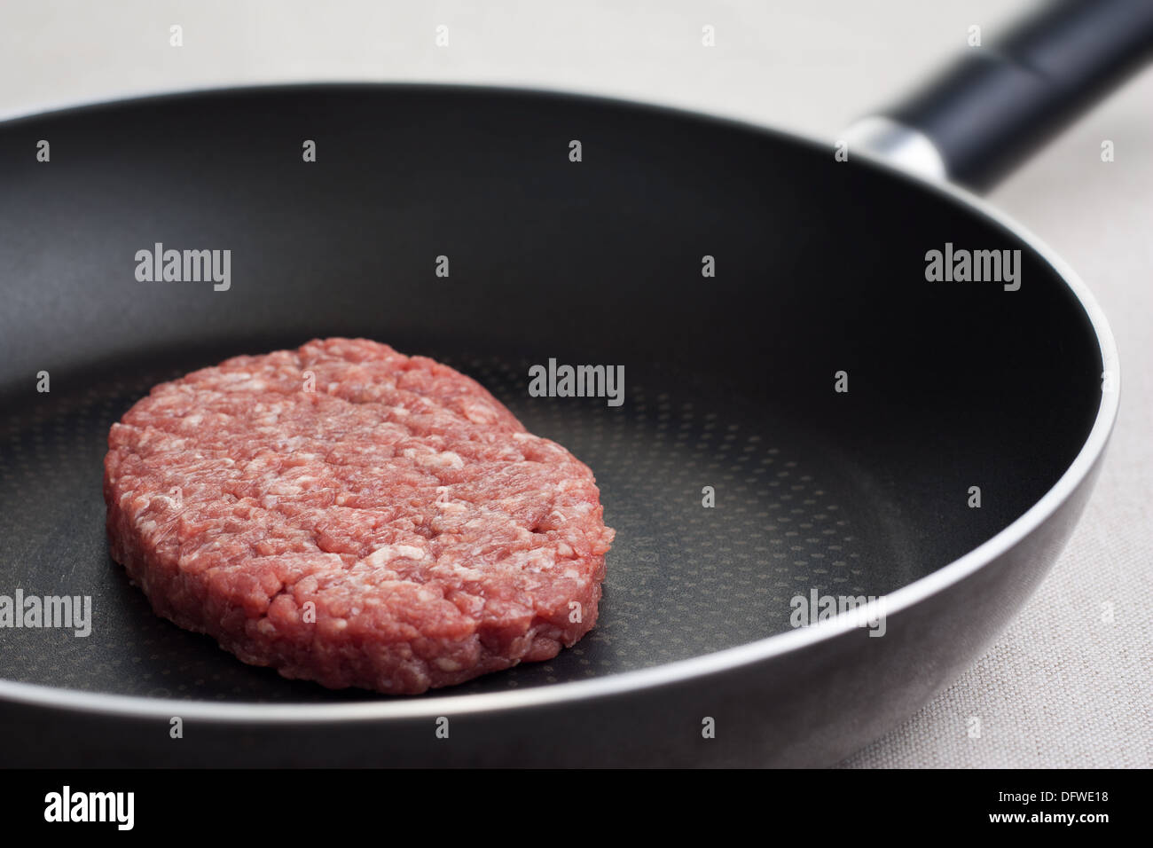 Raw hamburger frying on a pan Stock Photo Alamy