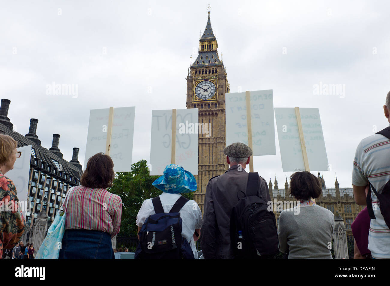 Protesters holding placards outside the Houses of Parliament in London UK Photo Credit: David Levenson / Alamy Stock Photo