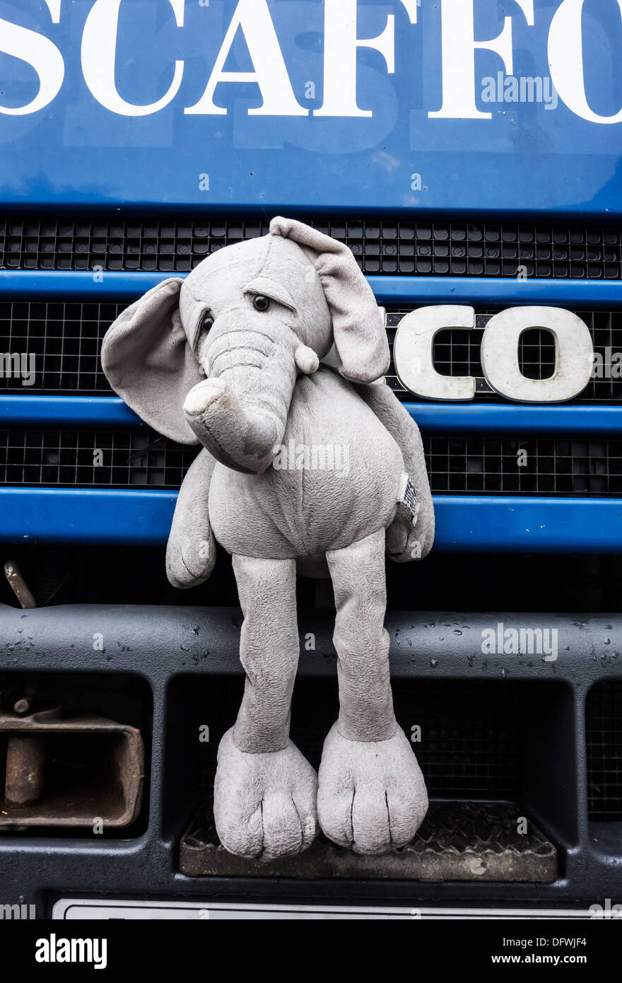 Sad elephant soft toy fastened to front of lorry as mascot Stock Photo