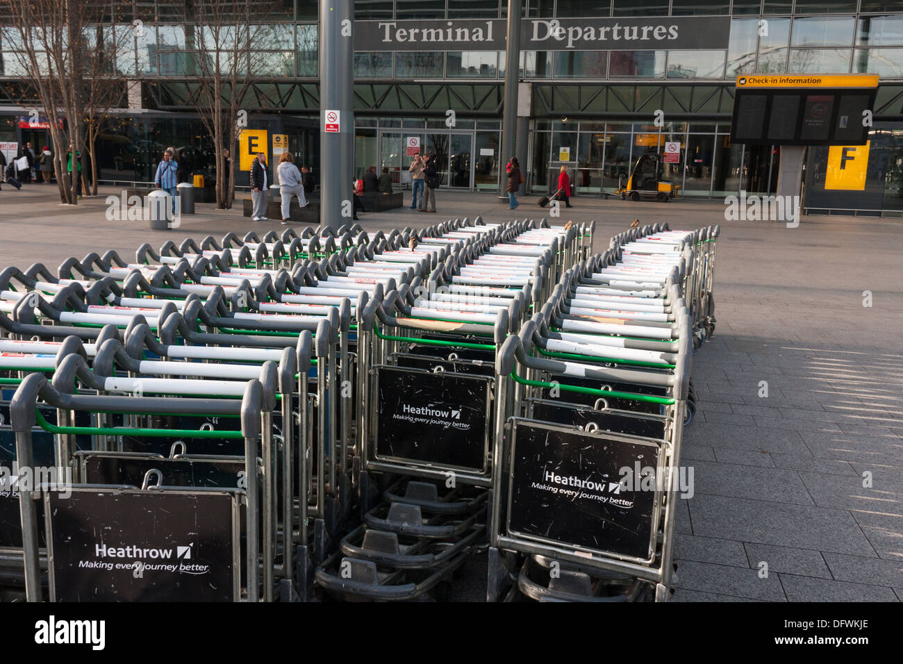 Rows of Airport luggage trolleys outside Heathrow Departures Terminal Three Stock Photo