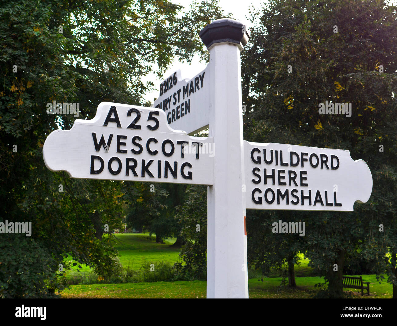 Traditional rural white English road sign on A 25 pointing towards Westcott and Dorking, Guildford Shere and Gomshall. Surrey UK Stock Photo