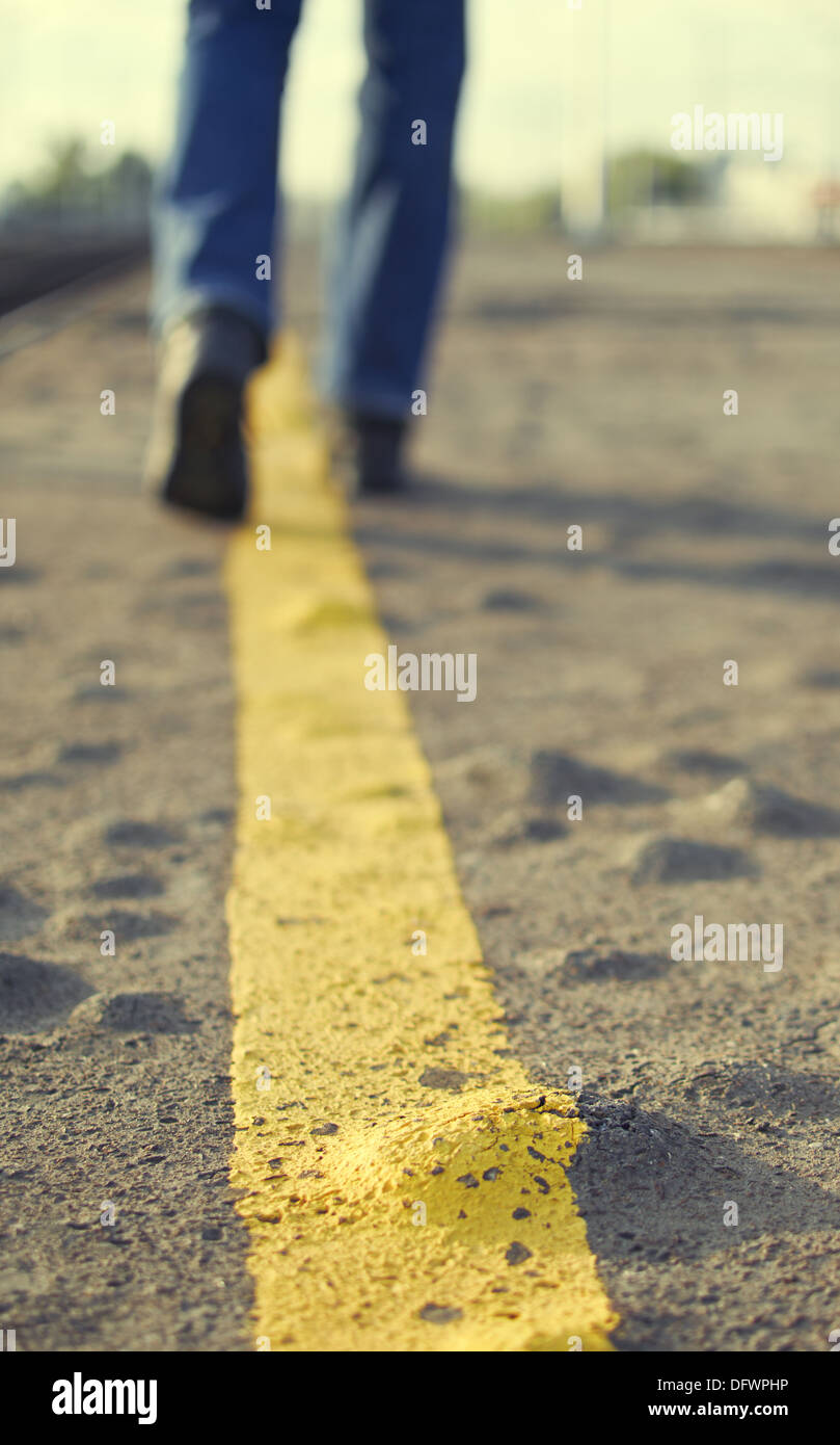 Person walking on asphalt road Stock Photo Alamy