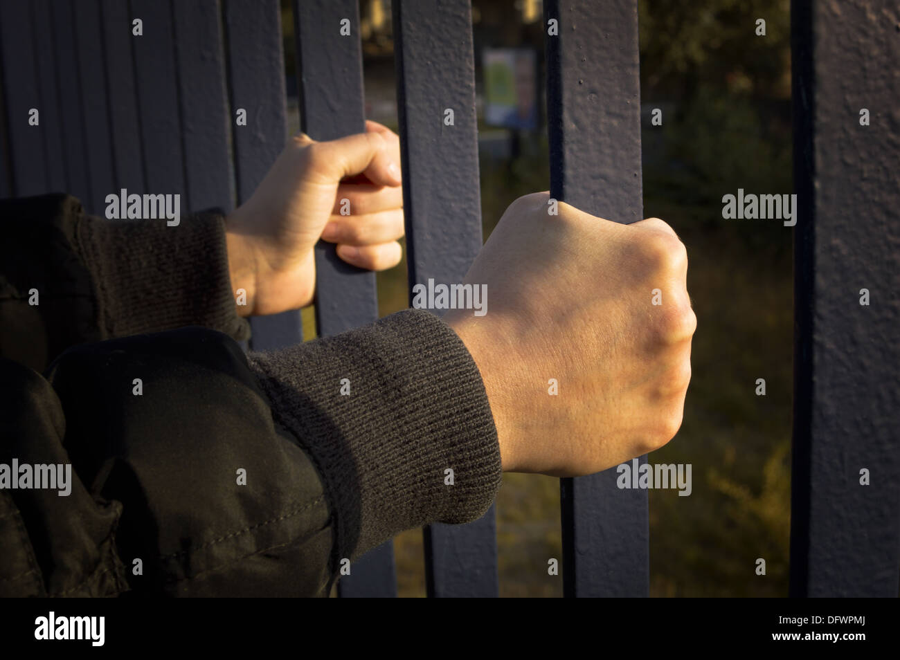 Hands holding the bars on both sides. Stock Photo