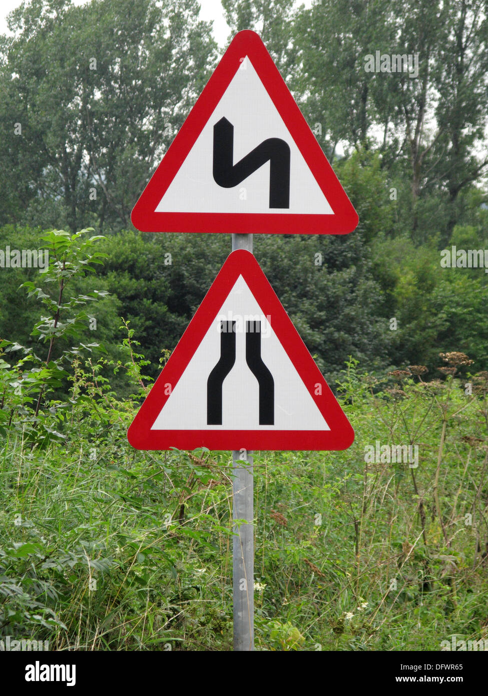 Red Triangle Caution and Warning Road Signs for a Narrowing Road and Bendy Road, UK Stock Photo