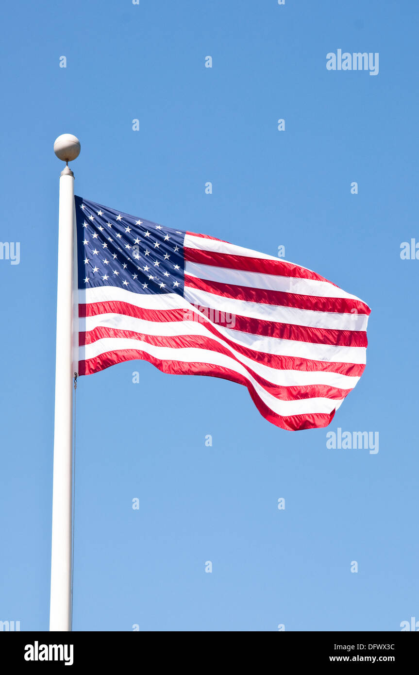 The stars and stripes, the national flag of the United States of America (the USA). The American national flag against blue sky. Stock Photo