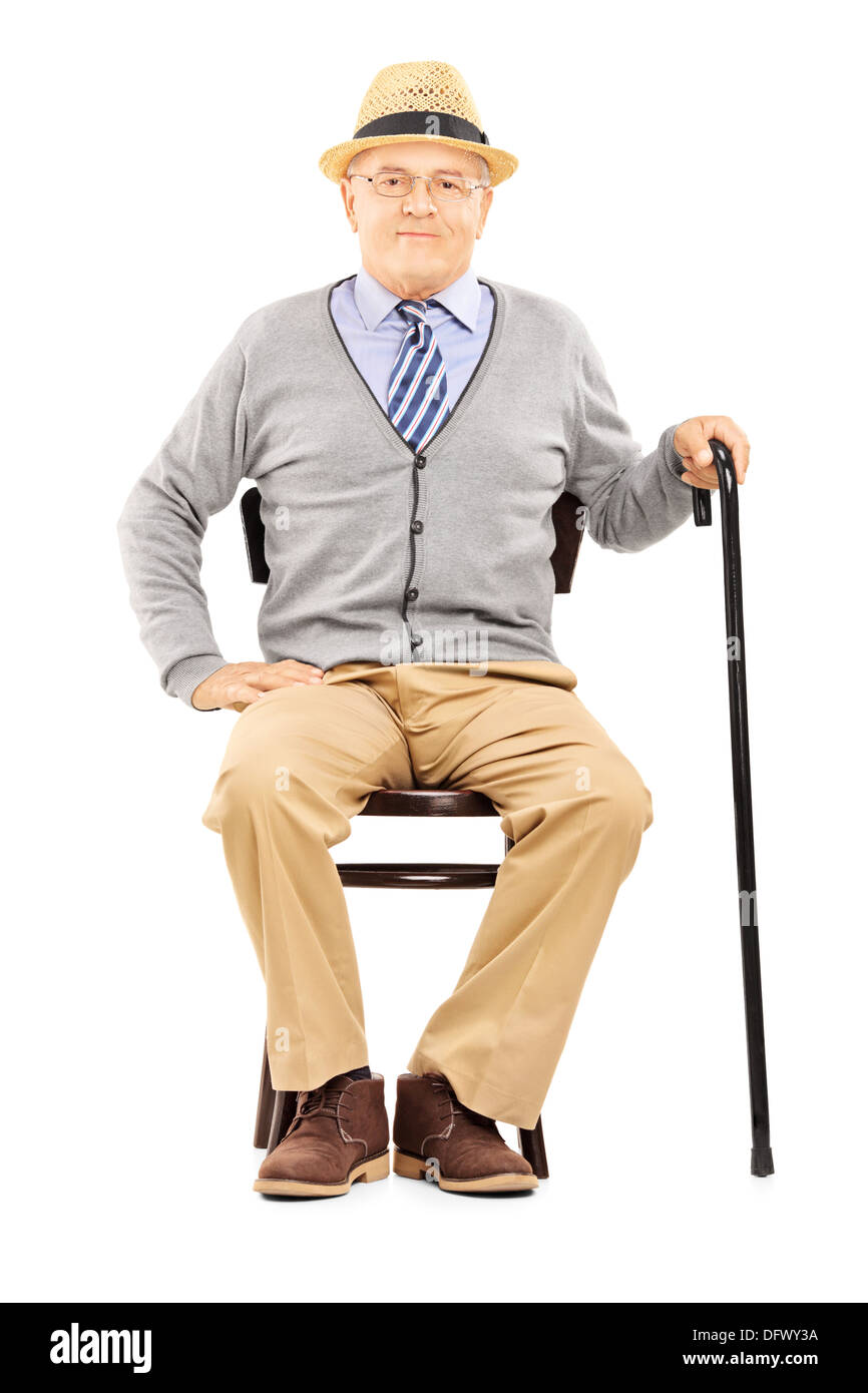 Relaxed senior man sitting on a wooden chair and looking at camera Stock Photo